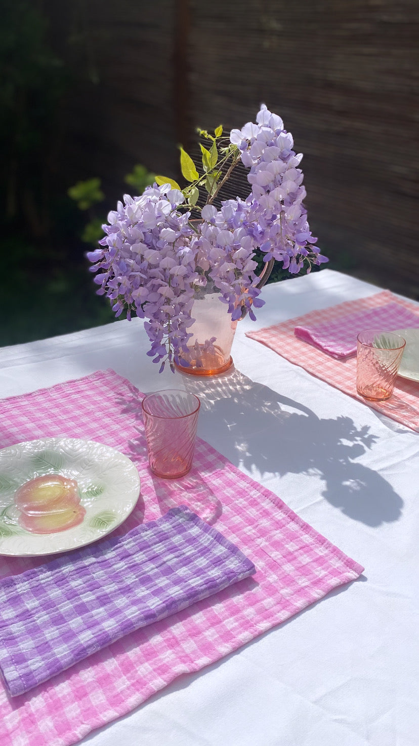 serviettes de Table en tissu double gaze de coton Vichy Glycine sur une table dressée avec set de table rose et un bouquet de fleur
